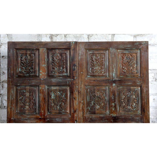 Bring timeless character and artisan craftsmanship into your home with this vintage hand-carved barn door, beautifully...