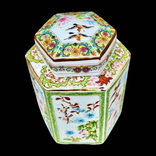 This hand-painted hexagonal porcelain ginger jar or tea caddy is a decorative example of Chinese Famille Rose style...