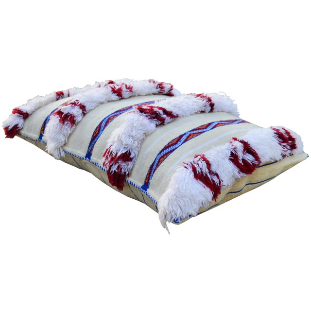 Handwoven Moroccan Berber wedding pillow from the High Atlas Mountains. Features alternating stripes of wool fringe,...