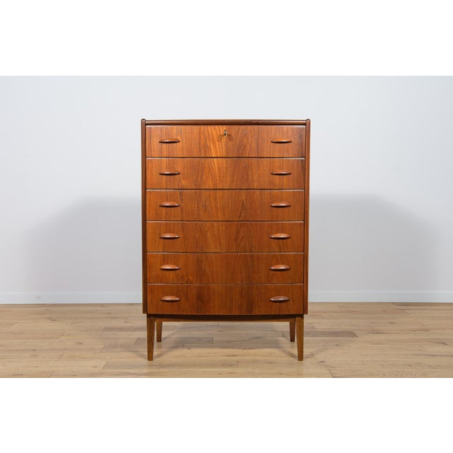 Teak dresser with six drawers made in the 1960s in Denmark. The dresser has contoured handles. The dresser has undergone a...
