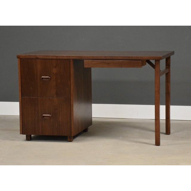 A mid century modern walnut desk with a single bank and finished back. Made in USA. Circa 1960’s. Professionally...