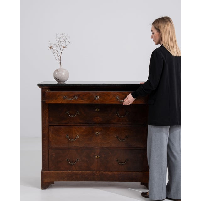 A sophisticated Biedermeier buffet featuring a rich mahogany finish and elegant marble top. The clean lines and lack of...