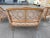 Elegant French settee with pink silk upholstery. Circa 1920, this settee is made of natural, light fruitwood and features...