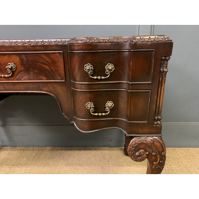A bold and impressive writing desk in the style of Thomas Chippendale. Dating from the early 20th century and well...