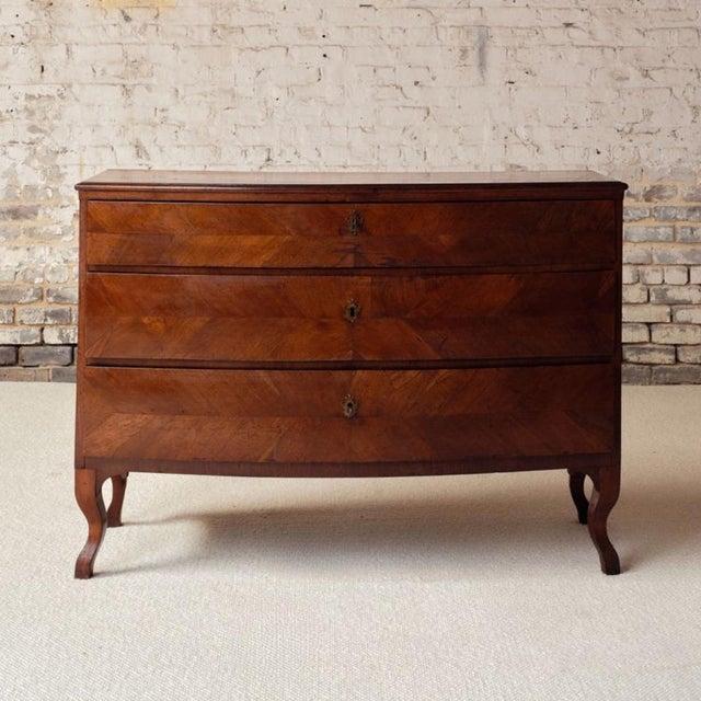 Elevate your interior with this exceptional 18th century French walnut chest of drawers, a refined antique showcasing...
