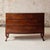 Elevate your interior with this exceptional 18th century French walnut chest of drawers, a refined antique showcasing...