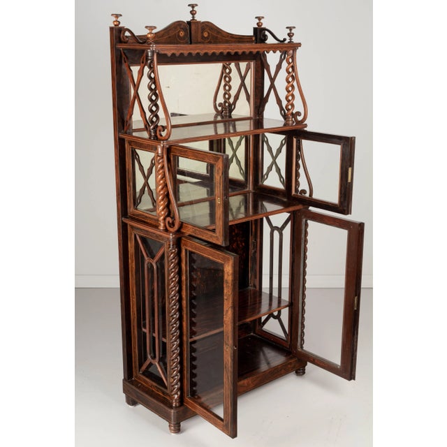 A 19th Century French Louis Philippe étagère, or display cabinet with shelves. Made of solid rosewood with fine lemon wood...