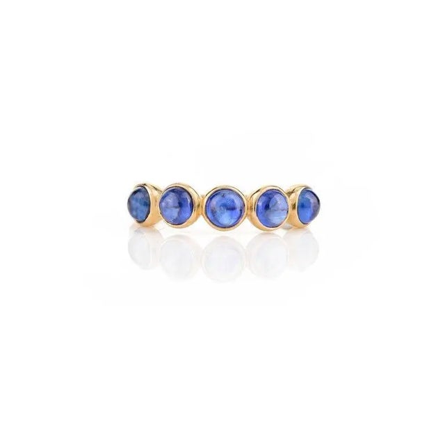 This is part of Chairish’s Fine Jewelry assortment. Blue Sapphire Bezel Set Band Stacking Ring in 14K Gold symbolizes the...