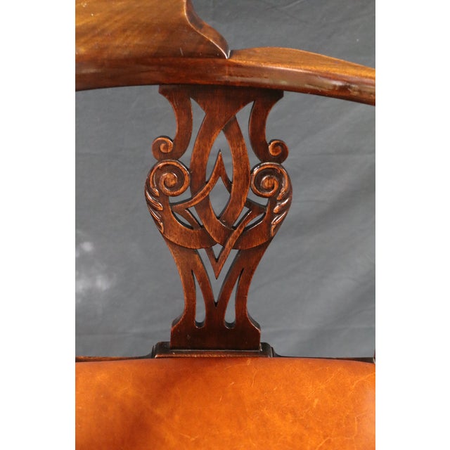 A beautifully carved antique corner chair, crafted in walnut( or walnut-tone hardwood) with elegant hand-carved detailing...