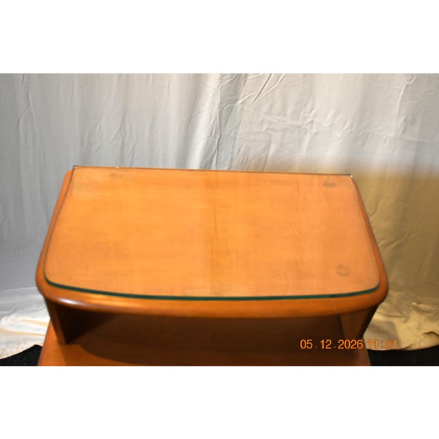 Heywood-Wakefield Company United States, circa 1950s–early 1960s The integrated pull, rounded edges, and floating shelf...