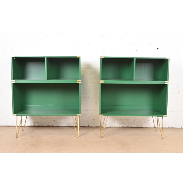 A sleek and stylish pair of mid-century modern Hollywood Regency Campaign style bookcases By Thomasville USA, Circa 1970s...