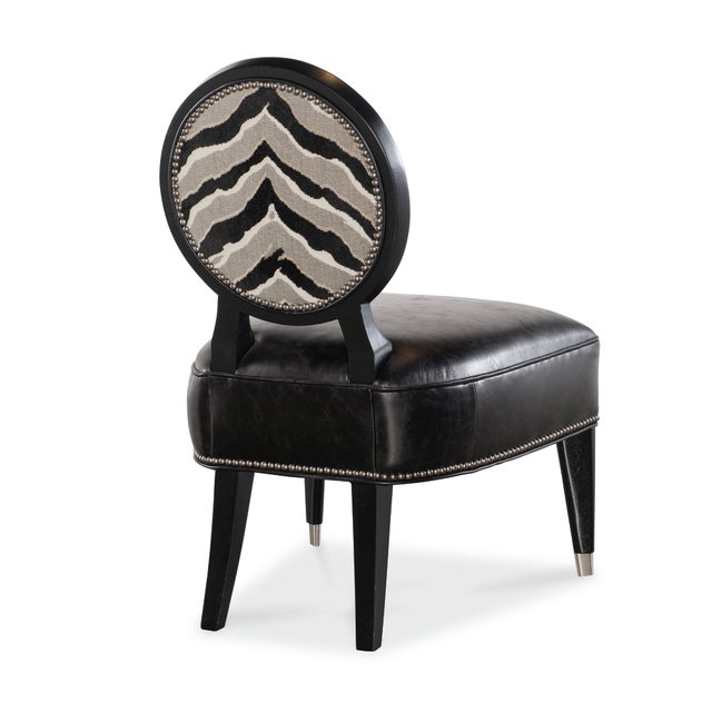 The Marielle Chair covers a rich mahogany frame with striped fabric and a smooth black leather seat—artful contrast with a...