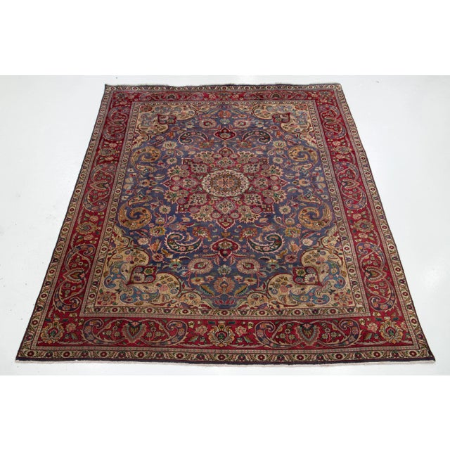 This beautiful Persian Tabriz wool rug has a blue field with multicolor accents all over the medallion motif. This rug...