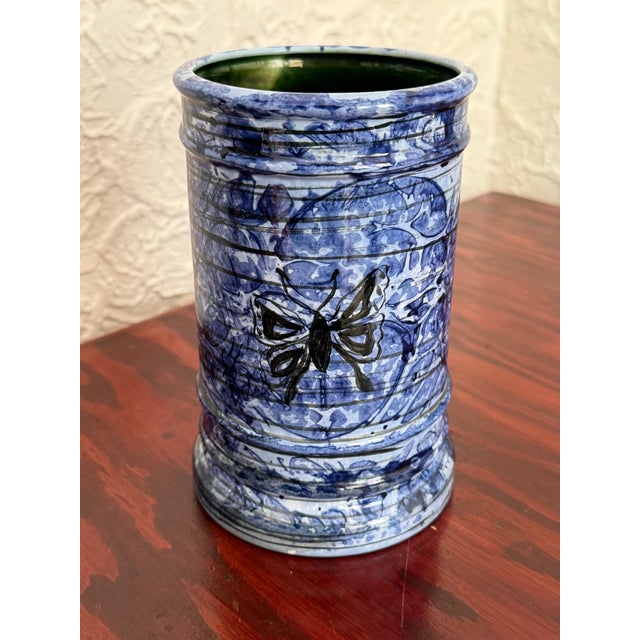 This pottery ceramic utensil holder is glazed in blues and decorated with black butterfly motifs. Studio made and signed...