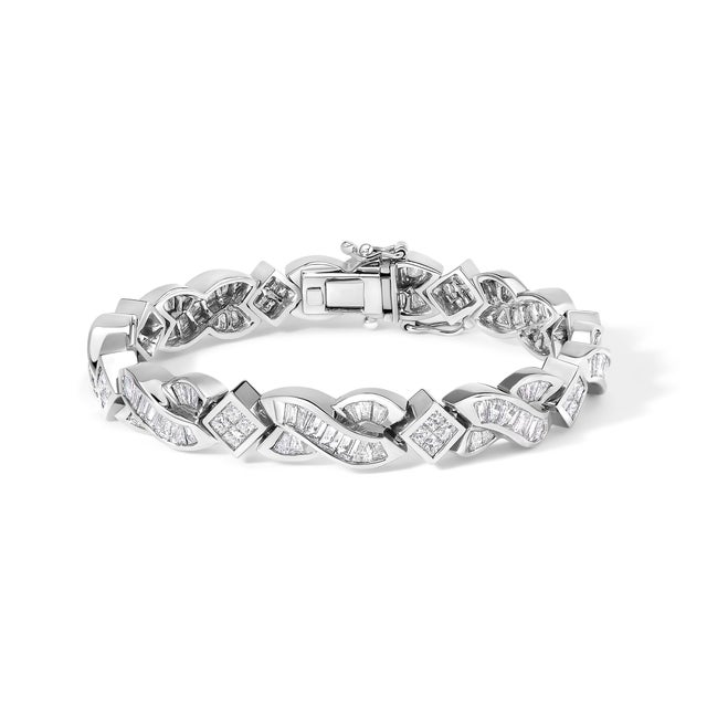 Crafted from pristine 14K white gold and lavishly adorned with 8 1/5 carats of dazzling natural diamonds, this bracelet...