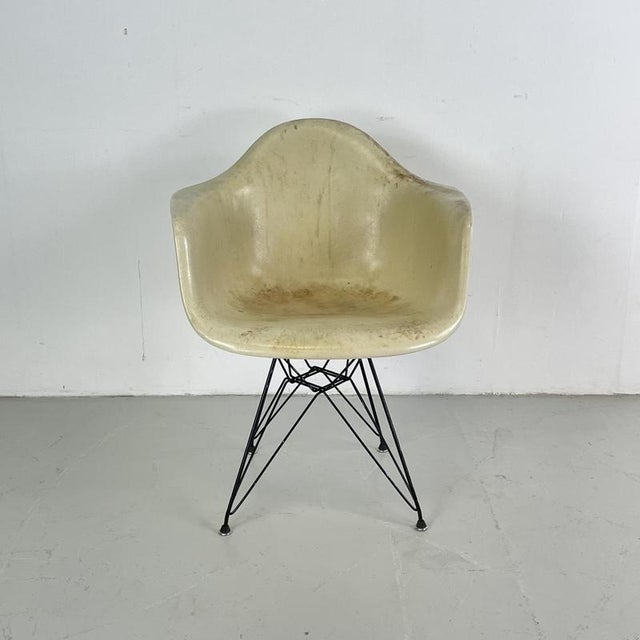 Original 1950s Charles Eames for Herman Miller chair in off white fibreglass shell on a black metal powder coated Eiffel...