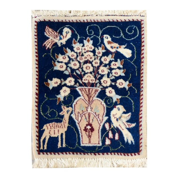 A wonderful pair of mid-20th century Persian Nain rugs each depicting a large central vase with flowers and birds perched...
