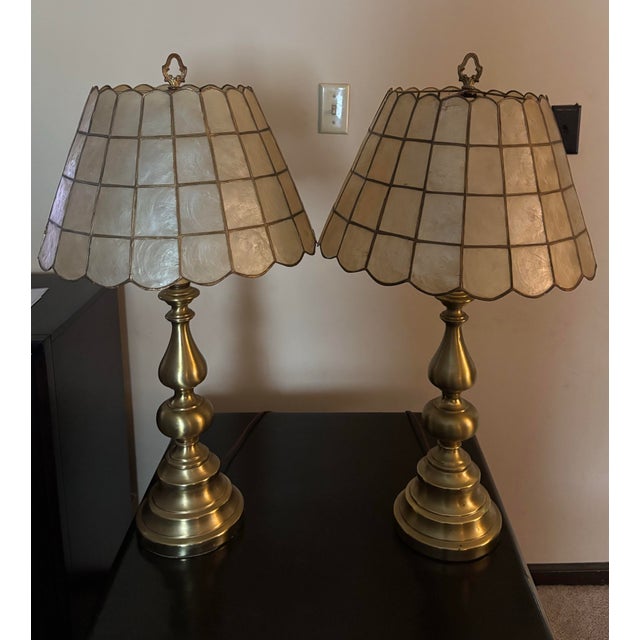 Circa 1970’s capiz shell shade, brass lamp set. In good working condition with original housing and cords.