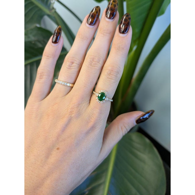 A 1.92ct tsavorite oval ring set in solid 14K yellow gold, set with twenty-four earth mined diamonds. Tsavorite is a rare...