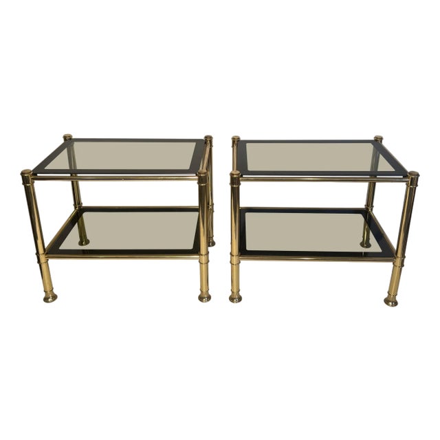 1970s Pair of brass side tables with smoked glass shelves For Sale