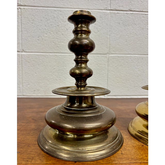 This is a gorgeous pair of vintage solid brass candlesticks or candlestick holders with traditional turned stems and wide...