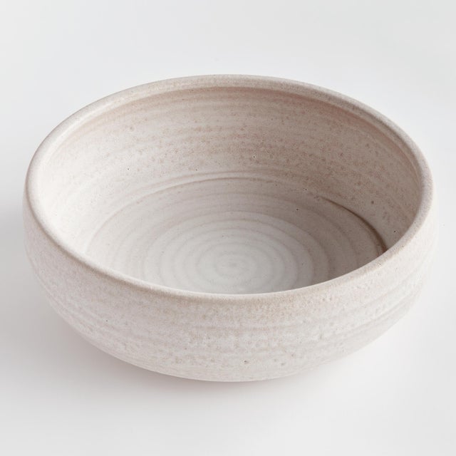 This handthrown decorative bowl has a weighty feel. Made with subtle ridges and a matte finish. Add some natural orbs or...