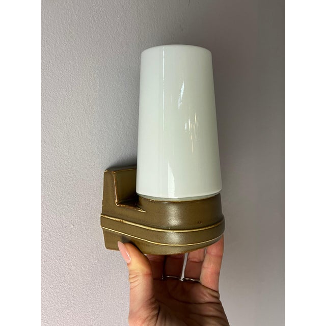 The Model 6080 wall lamp in ochre brown by Sigvard Bernadotte for Ifö Electric is a classic of Swedish design. The angular...