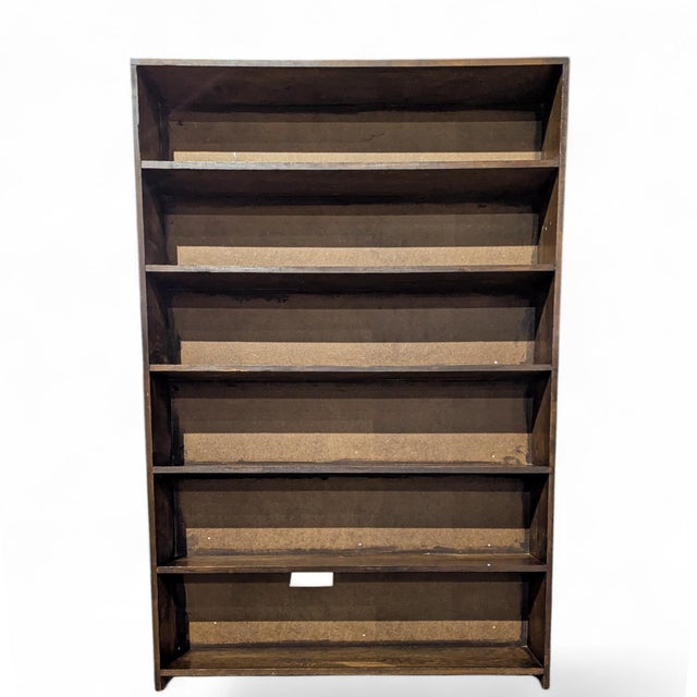 A warm vintage pine bookcase with five open shelves and a clean, narrow profile. Its shallow depth makes it especially...