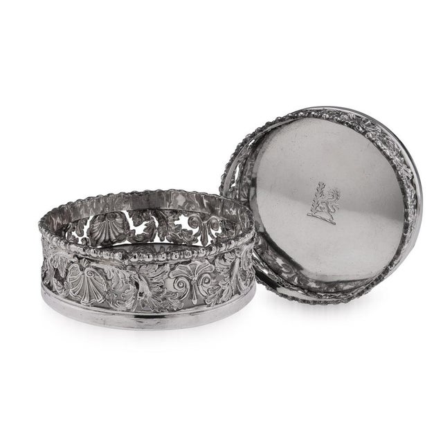 19th Century pair of Georgian silver large wine bottle coasters, circular form, with shell, scroll and rocaille boarders,...