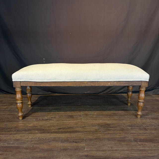A refined 19th century French walnut bench featuring gracefully turned legs and a beautifully figured walnut frame. Newly...