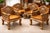 An intricately carved seating group made of solid teak, consisting of four armchairs and a matching coffee table. Balinese...