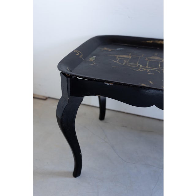 A striking blend of form and artistry, this ebonized chinoiserie coffee table from France features a beautifully hand-...