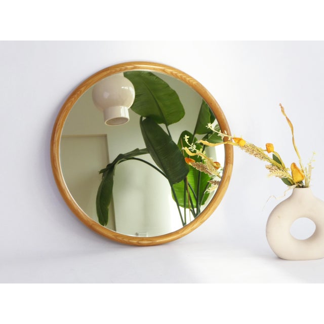 A round shaped vintage original wooden mirror from the 70's. The wall mirror is made in the Netherlands and branded by...