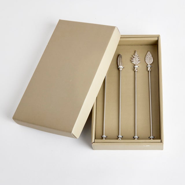 Crafted in stainless steel and finished in a sparkling silver, these swizzle sticks are adorned with assorted leaf motifs....
