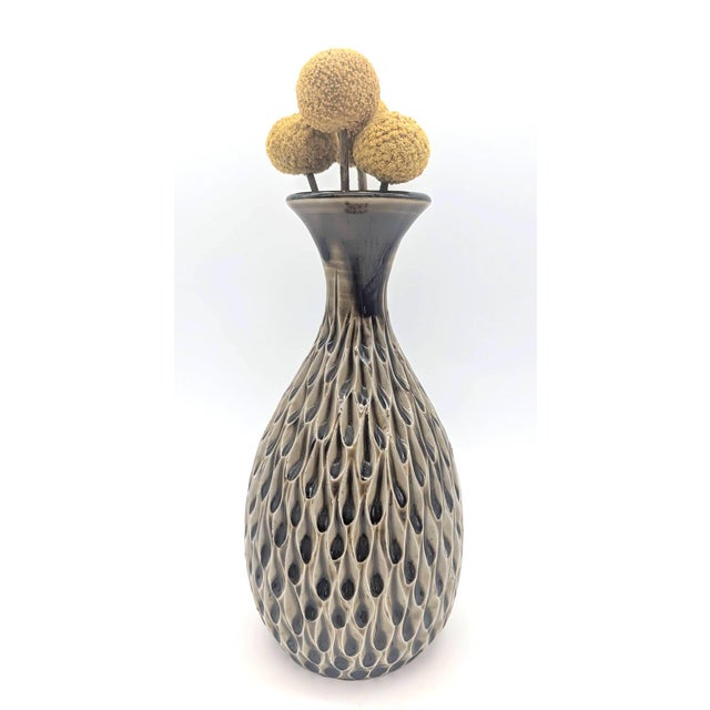 Offered is a 1970s wheel-turned studio pottery bud vase that has a distinct onion-shaped neck and a textured surface with...