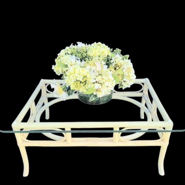 ​Embrace effortless coastal elegance with this stunning vintage mid-century Ficks Reed rattan style coffee table. The...