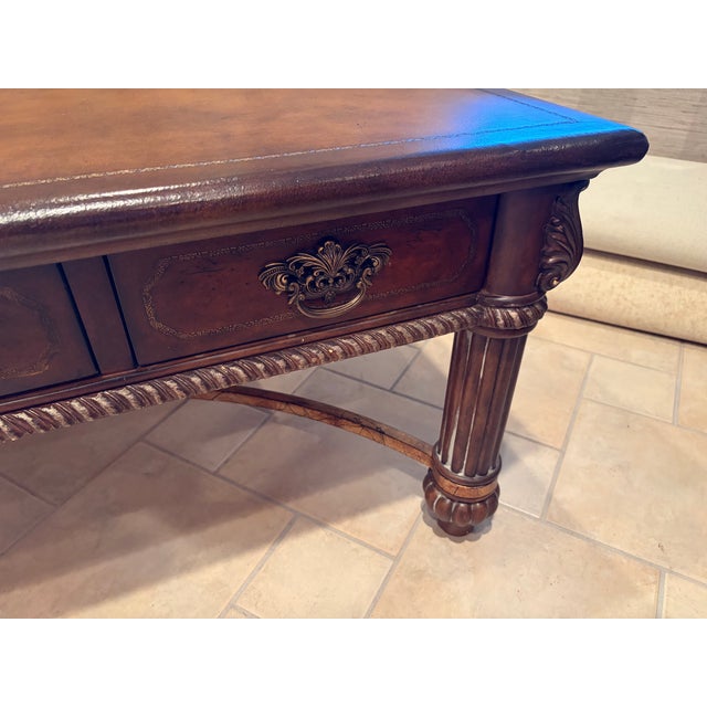 This classic piece makes a handsome addition to any room. Leather wrapped top with hand tooling details along perimeter....