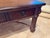 This classic piece makes a handsome addition to any room. Leather wrapped top with hand tooling details along perimeter....