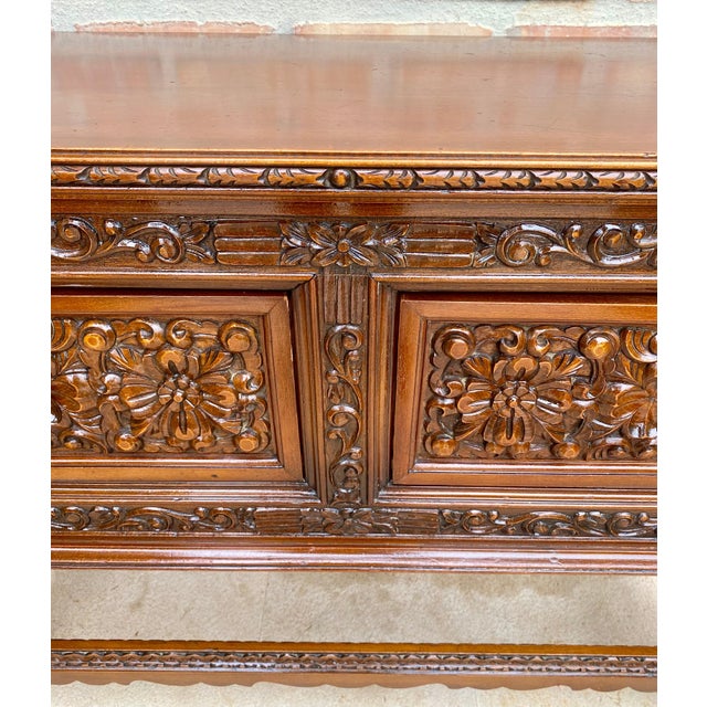 This large Spanish piece of furniture from the early 20th century features a beautiful rectangular one-slat countertop on...