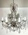 French 8-light crystal chandelier featuring star-etched crystals and garlands of macaroni beads, giving a unique and...