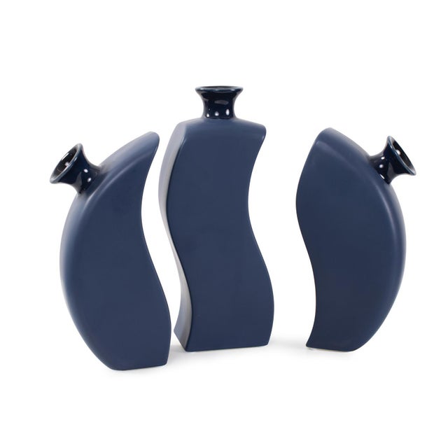 This vase features a matte blue body and a glossy blue opening, creating a harmonious contrast. The pieces interlock to...