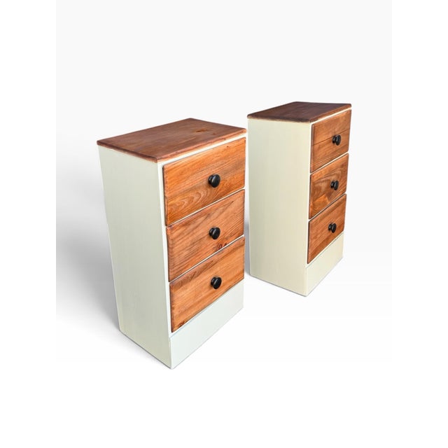 A charming matching pair of vintage handmade solid-wood nightstands featuring compact proportions, warm natural wood...