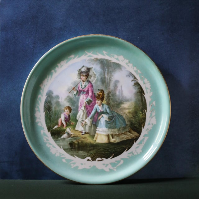 Large early 20th-century French Sèvres porcelain charger, measuring 17 3/4 inches in diameter. The center is finely hand-...
