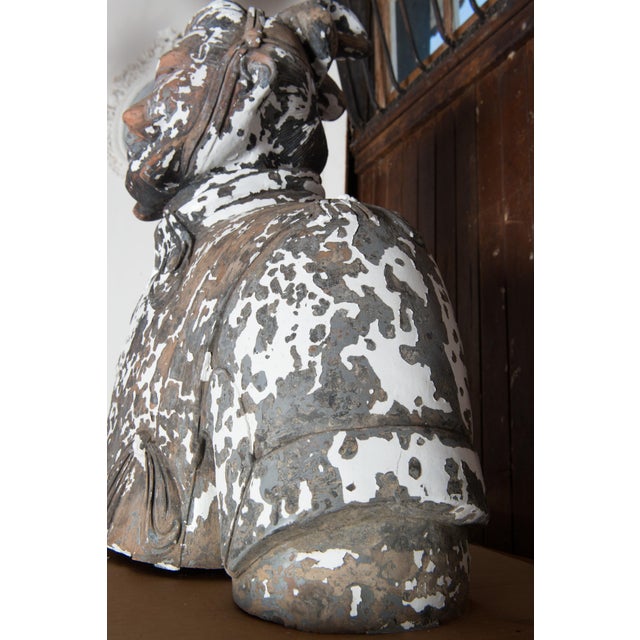 A large and heavy terracotta bust of an Asian warrior. The head is a separate piece that fits into the neck. This bust has...