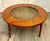 Here is a fabulous, Mid-Century Modern round coffee table featuring a beautifully bookmatched wood veneer top surrounding...