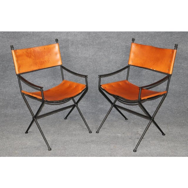 A stylish and sophisticated set of four mid-century modern armchairs in the manner of celebrated French designer Jacques...
