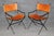 A stylish and sophisticated set of four mid-century modern armchairs in the manner of celebrated French designer Jacques...
