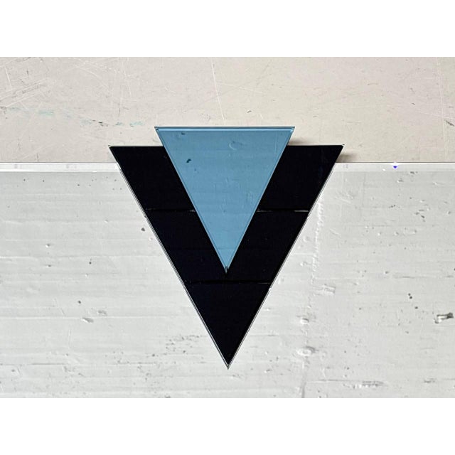 Exceptional wall mirror from the iceberg espe series with a striking, sculptural triangular shape. The clean geometry is...