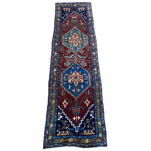 An outstanding antique Heriz runner in near original condition, hand woven circa 1910. The design features two lozenge...