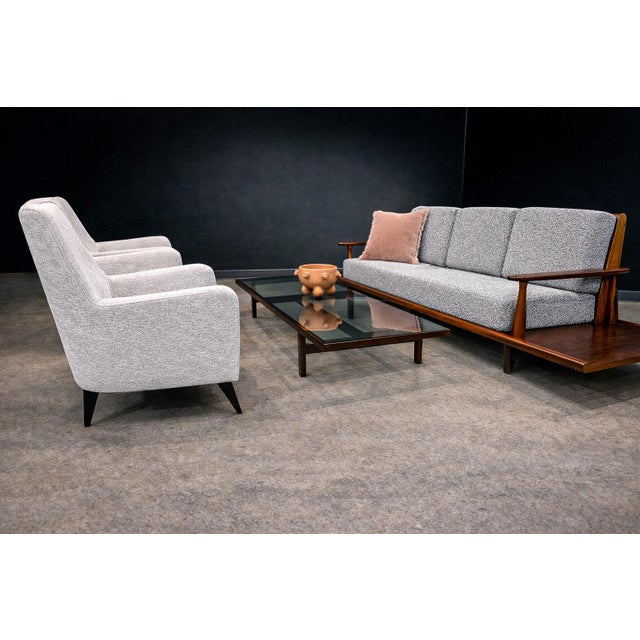 Designed by Joaquim Tenreiro (1906–1992) and produced by Tenreiro Arquitetura de Interiores S.A., this pair of armchairs...